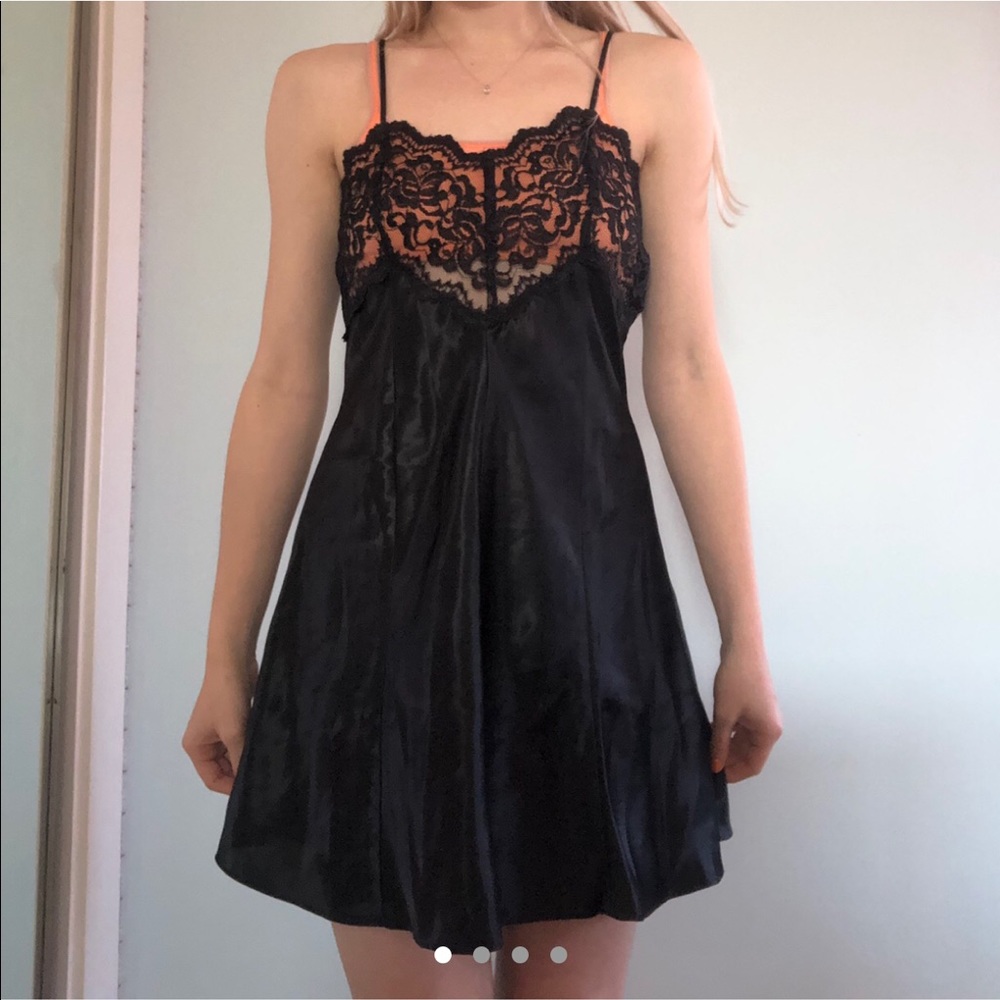 Dainty black slick slip dress.